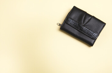 Womans wallet on an isolated yellow background.