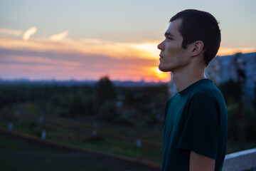 Fototapeta premium Melancholic male urban portrait. Stand on the bridge and look into the distance