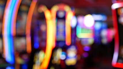 Defocused slot machines glow in casino on fabulous Las Vegas Strip, USA. Blurred gambling jackpot...