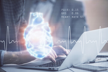 Heart drawing with man working on computer on background. Medical concept. Double exposure.