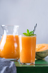 Fresh organic melon cantaloupe smoothie on a kitchen table