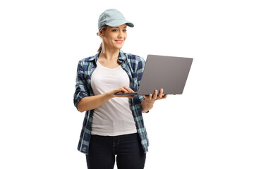 Young woman with a cap and a checkered shirt working on a laptop computer