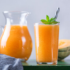 Fresh organic melon cantaloupe smoothie on a kitchen table