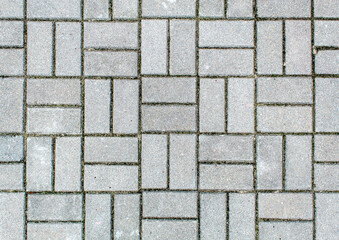 road paved with sidewalk tiles. texture of light gray bricks.