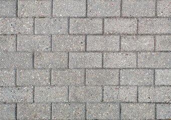 road paved with sidewalk tiles. texture of light gray bricks.