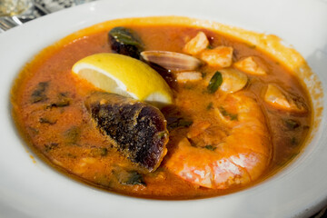 Maltese tomato seafood soup with giant shrimps, clams, mussels, fish and calamari