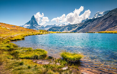 Sunny summer view of Stellisee lake. Breathtaking outdoor scene with Matterhorn (Monte Cervino,...