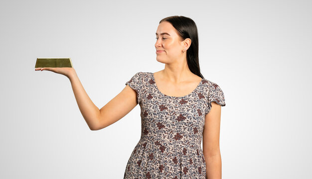 Young Woman Is Holding A Gold Bar On Her Hand