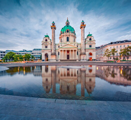 Naklejka premium Dramatic spring view of baroque church Karlskirche (St. Charles's Church), the most outstanding baroque church in Vienna. Splendid morning scene of capital of Austria. Traveling concept background..