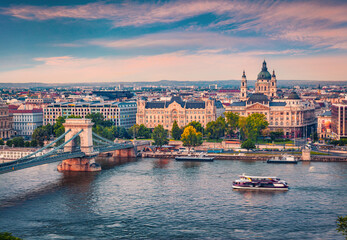 Fototapeta na wymiar Picturesque cityscape of Budapest, Hungary, Europe. Wonderful evening view of Saint Stephen's Basilica (St Istvan's) church and Szechenyi Chain Bridge over the Danube river.