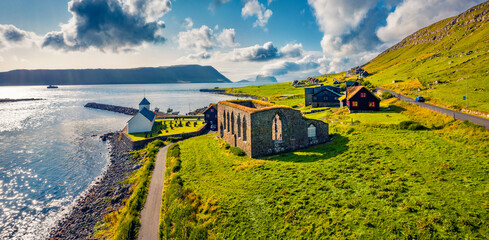Panoramic summer view from flying drone of Kirkjubour village with Hestur Island on background. Attractive morning scene of Faroe Islands, Denmark, Europe.  Traveling concept background.. © Andrew Mayovskyy