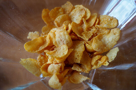 Corn Yellow Flakes In A Glass Dish Top View . Gluten-free Snack