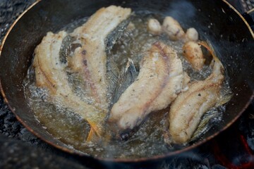 The preparation of the fish caught on fire.
