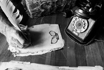 antique manuscript atmosphere, vintage writing items on wooden table with old telephone