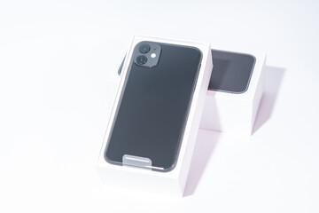Fototapeta na wymiar Black smartphone with two cameras on a white background