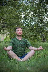Young meditative guy at nature. People of new world, changing time
