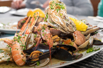 Delicious seafood platter from Malta  - freshly caught and grilled octopus tentacles, calamari rings in tempura, giant shrimps, clams, fish fillets and mussels 