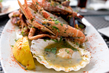 Delicious seafood platter from Malta  - freshly caught and grilled octopus tentacles, calamari rings in tempura, giant shrimps, clams, fish fillets and mussels 