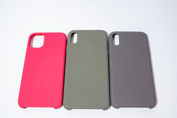Cases for smartphones in different colors on a white background
