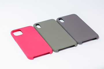 Cases for smartphones in different colors on a white background
