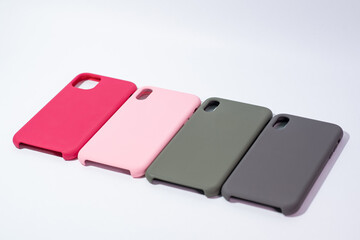 Cases for smartphones in different colors on a white background