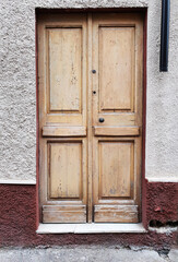 Old vintage wooden front door in an italian city. 30 August 2020, Rome, Italy 