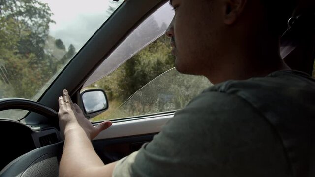 middle eastern guy driving in sunny summer day
