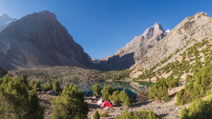 Fototapeta na wymiar Tajikistan. Sunrise in Fann mountains. Picturesque view on Alaudin lake. Hiking in mountains.