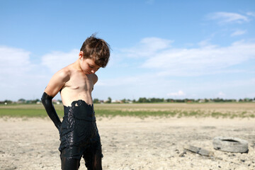 Boy Covered in Mud