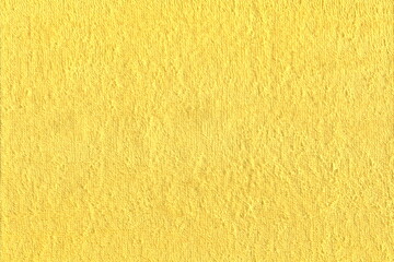 Texture of natural yellow cotton Terry cloth with lint. Abstract background of yellow fabric with pile.