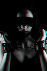 portrait of a female slave with a bandage on his face and leather handcuffs BDSM sex and...