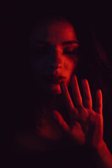 Sensual portrait of sad girl with smeared mascara through glass