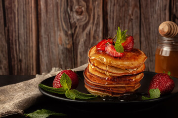 Delicious, only baked pancakes with fresh aromatic strawberries