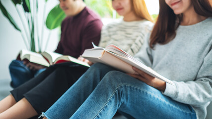 Group of young people sitting and enjoyed reading books together