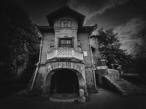 The Hunting Castle at Manuc Bei mansion, an architectural, culture and historic complex, Hincesti city, Moldova. Old brick building, black and white photo. Halloween haunted house concept, ghost home.