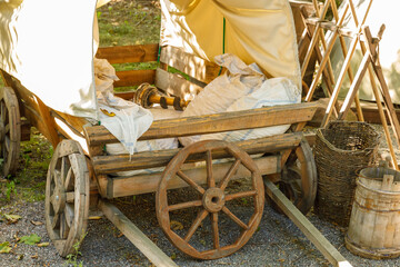 in the village there is an old wooden cart with a canopy.