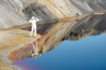 Astronauts woman wear helmet observe planet Mars and red lake. female Astronaut on the Moon with...