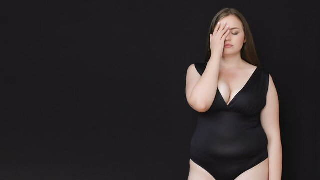 Upset depressed plump lady closing face with hand, shy of her body, template