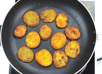 Frying crispy potatoes on a frying pan