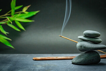 Spa zen basalt stones and green bamboo leaves on white background. The concept of wellness,...