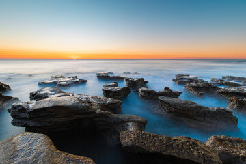 Sunrise view around the rocky platform at Coalcliff Beach, Sydney, Australia.