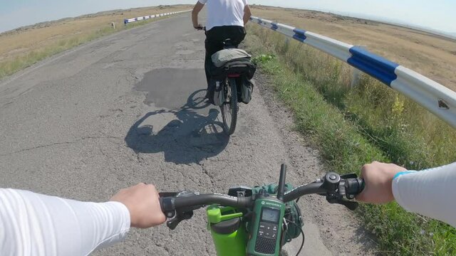 Armenia, 08.19.2020 Man rides bicycle on road. Man rides bicycle on road.  Action camera go pro. View from first person perspective. 
The radio is attached to the steering wheel of the bicycle.