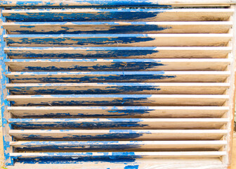 Old natural, wood blinds with scuffed blue paint, beautiful natural background