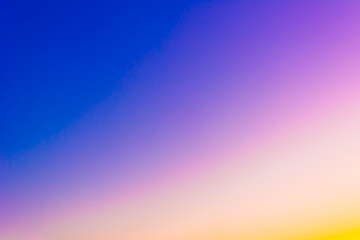 Sunrise and sunset. Bright sky. Twilight colors. Saturation. Light Blue, Blue, Yellow, Purple, Orange. Background with space for text.