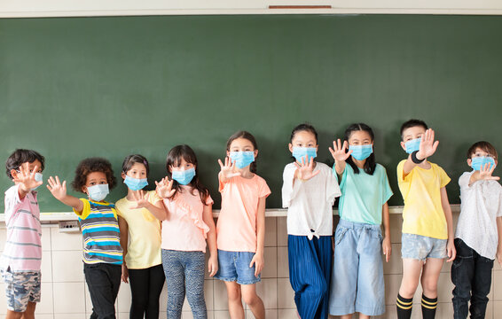 Group Of Diverse Young Students Wear Mask And Showing NO Sign Gesture In Classroom