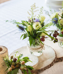 
A fragment of a rustic banquet table decor for a romantic atmosphere.