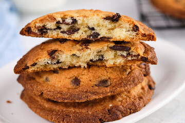 American chocolate chip cookies with chocolate on light marble background. Delicious dessert, close up