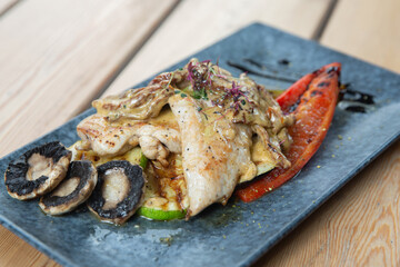 chicken with vegetables on a wooden background