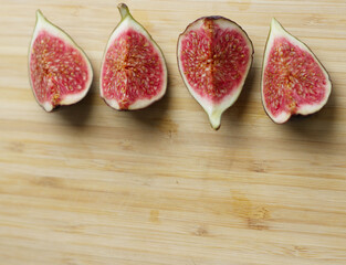 halves of figs laid out on top, on a wooden surface with space for text, inscriptions. Delicious...