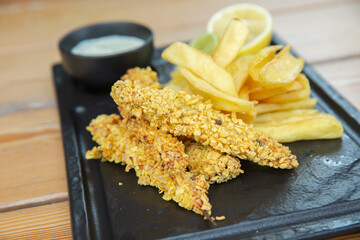 cornflakes breaded deep fried chicken crispy strips and lemon and potatoes